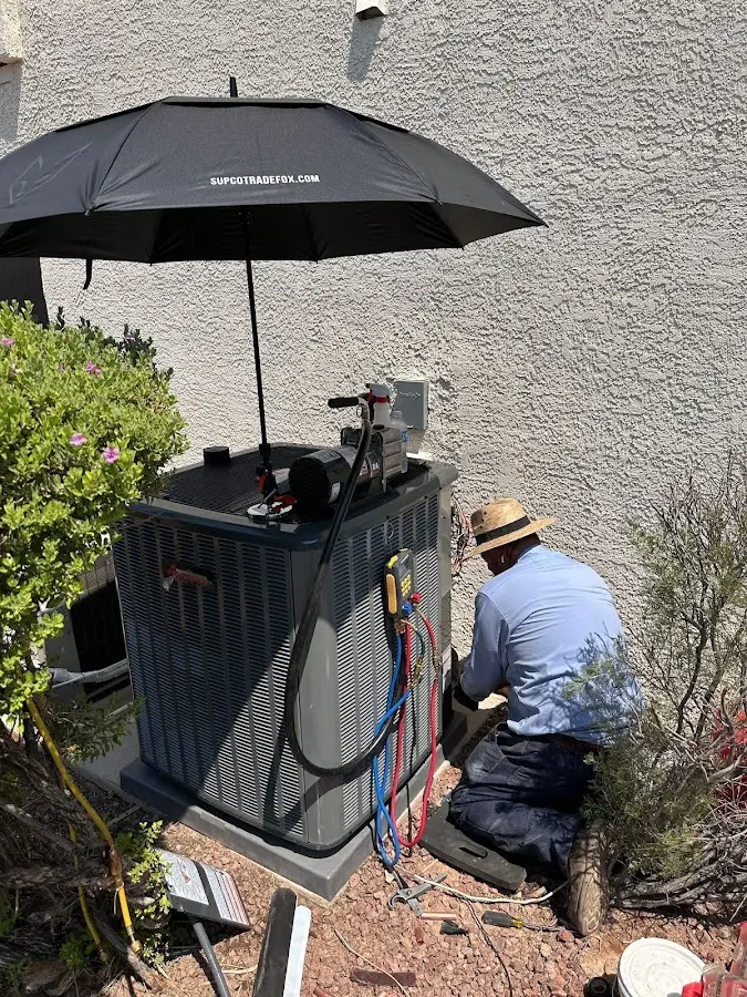 HVAC technician performing outdoor AC maintenance in South Gate